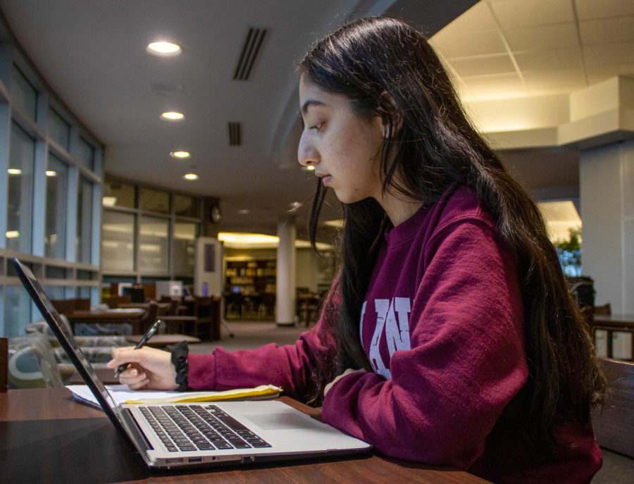 Senior Emily Natanova sits in the library while working on assignments for one of her online classes, Oct. 27. 