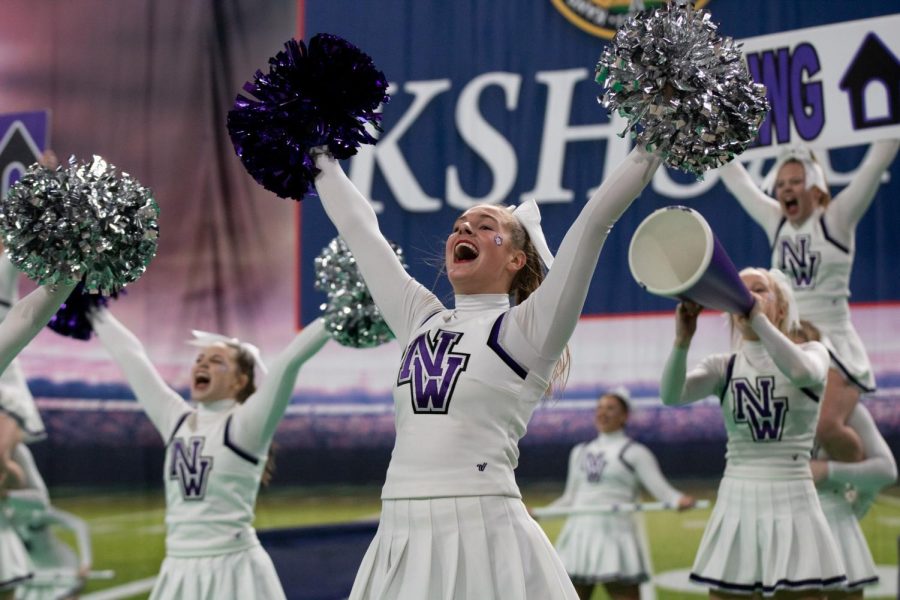 Senior cheer captain Kate Newby performs alongside the Northwest state team during the 6A state competition, Nov. 19.