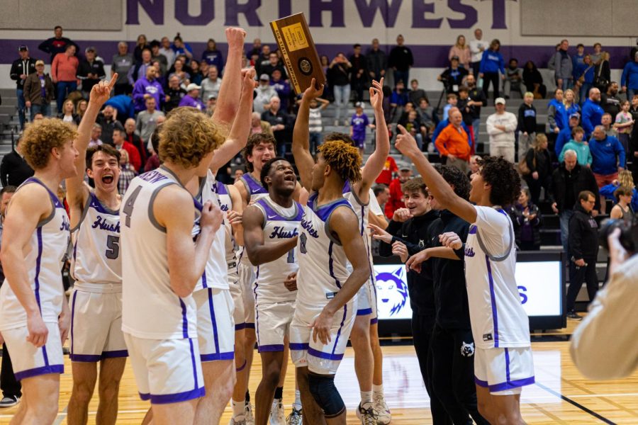 After defeating Olathe Northwest in the Sub-State championship, the boys varsity basketball team celebrates their win. Senior Grant Stubblefield holds up the plaque. 