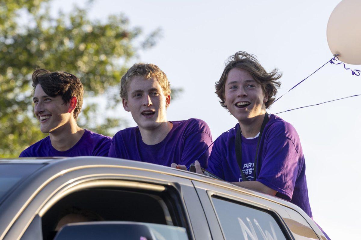 Players represent the boys soccer team in the Homecoming parade.