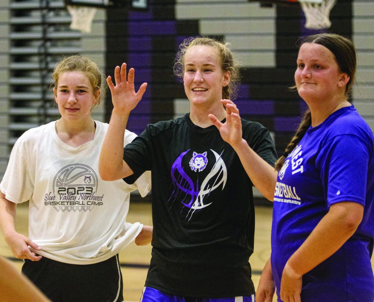 During an open gym with the girls basketball program, senior Josie Grosdidier prepares to high-five a team mate. 
