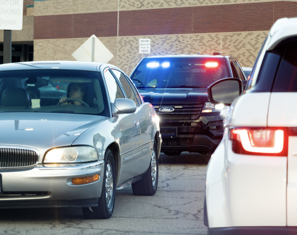 Overland Park police officer pulling someone over for illegally turning left from Switzer into the Blue Valley Northwest drop-off line on Sept. 27.