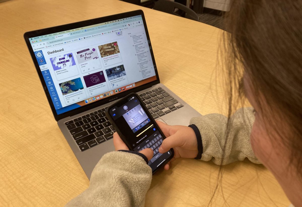 Photo illustration of a student using their cell phone while in school.