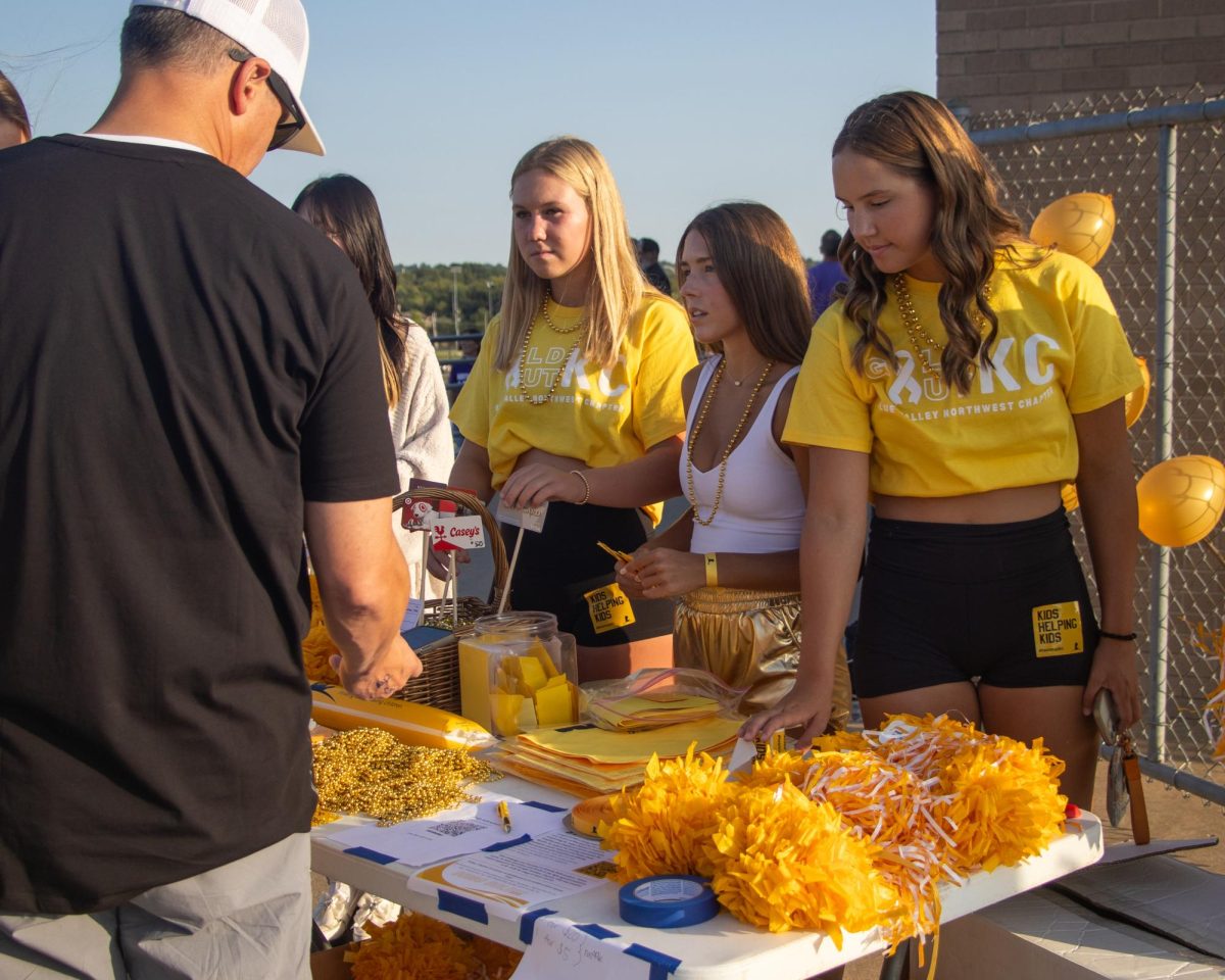  Members of Blue Valley Northwest’s Gold Out KC club educate visitors about their mission at the varsity football game on Sept. 6.