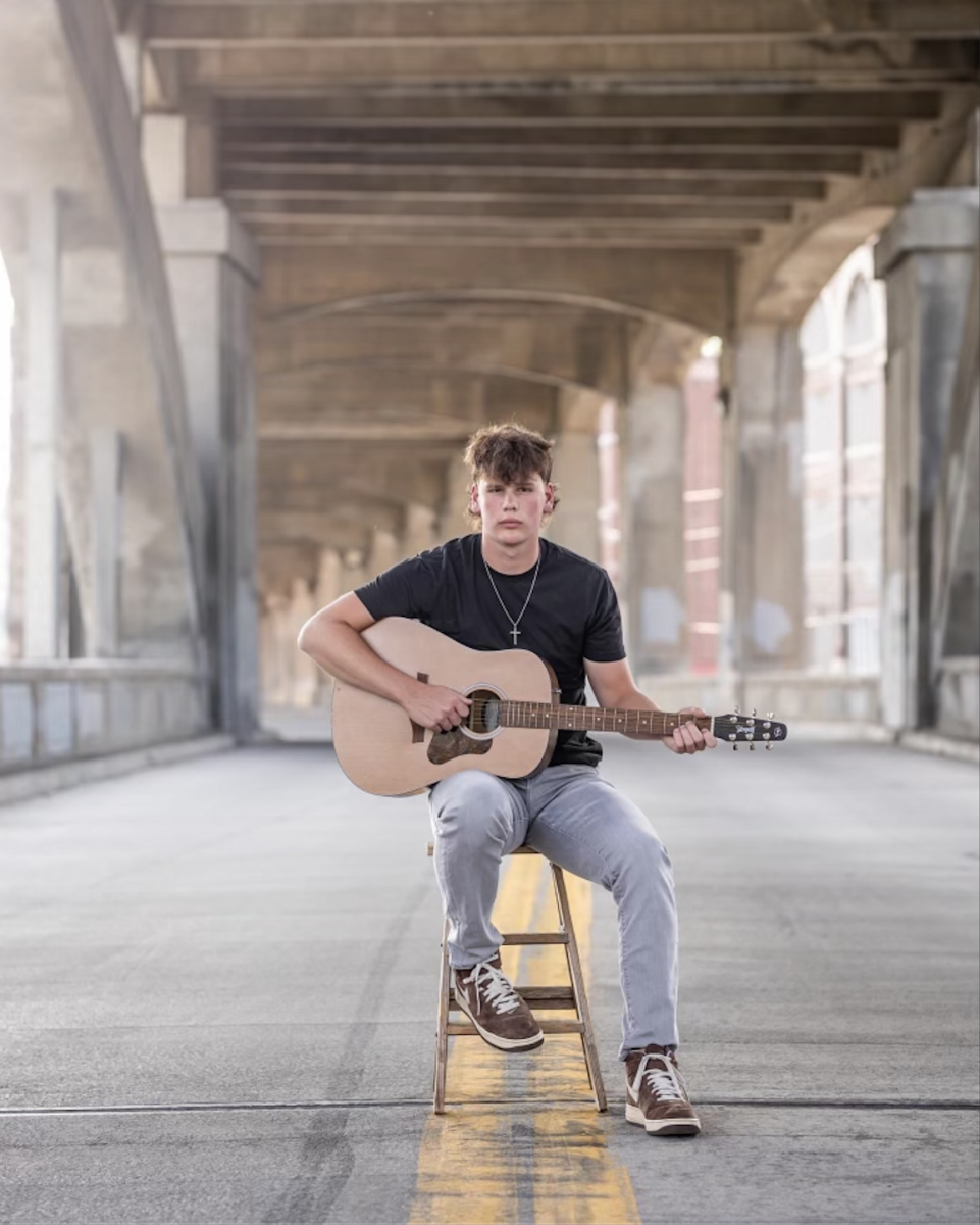 Bevins poses with his guitar in his senior pictures. “Playing guitar is a way to express myself,” he said, “I have always loved music and it has always been an outlet for me.”