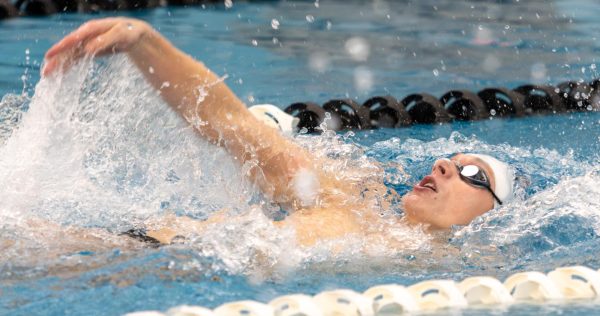 Senior swimmer John Christianson performing the back stroke.