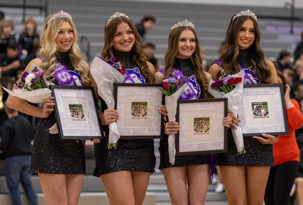 Seniors Addie Wight, Bella Hopkins, Macie Gorman and Kat Davis pose for a picture during their senior night Jan. 14. “All four of them just hold themselves really well,” Head coach Hannah Haworth said. “They're nice, kind and caring, and I think that helps the younger dancers look up to them.”