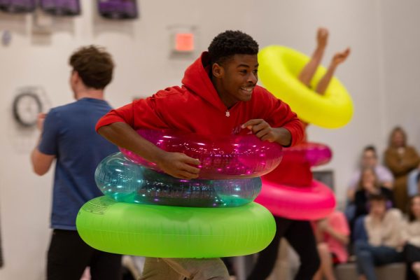 Sophomore Keon King rushes down the basketball court during the tube toss relay at the Sweetheart assembly Feb. 10.