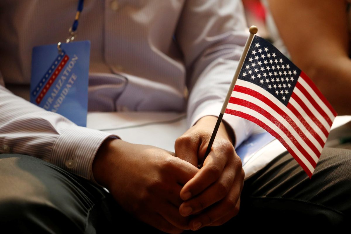 A new citizen holds a U.S. flag at the U.S. Citizenship and Immigration Services (USCIS) naturalization ceremony at the New York Public Library in Manhattan, New York, U.S., July 3, 2018.
