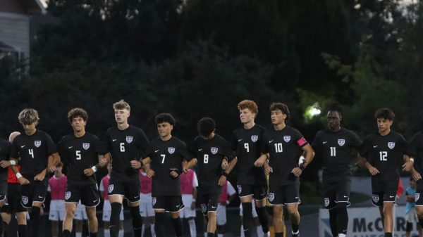Soccer team defeated in opening game on newly named field.