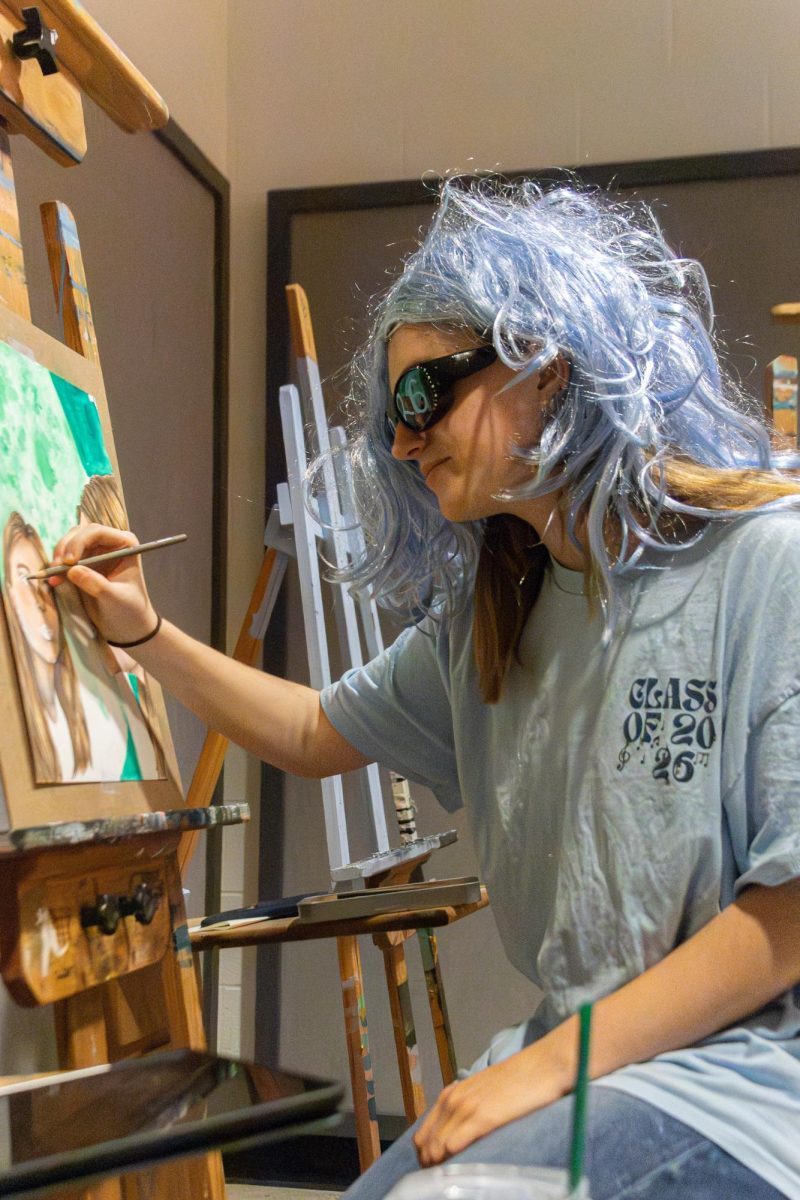 At the start of her Portfolio Seminar class, senior Lizzie Herron picks up where she left off on her narrative art piece on Sept 25.
