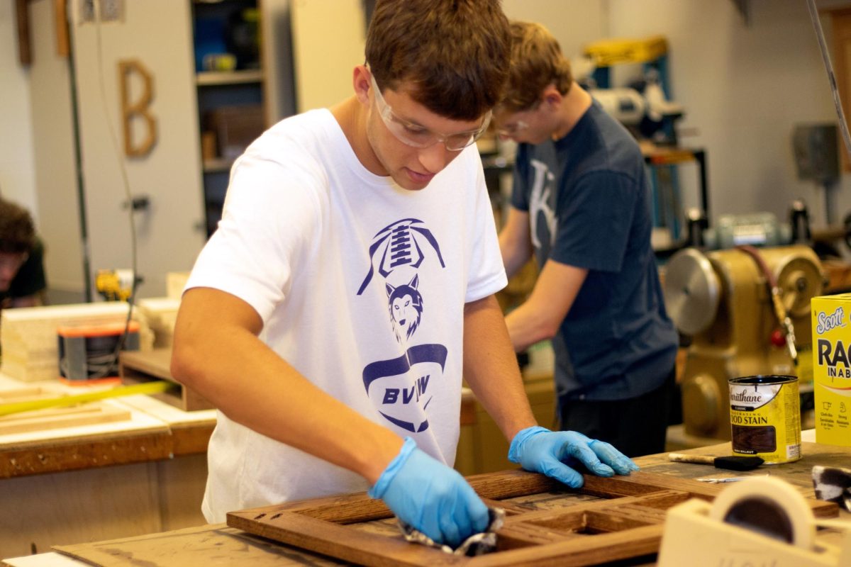 In Mr. Masten's woodtech room, junior Dylan Hotze shows off his woodworking skills. “Expressing my creativity and opening my mind to that project.”