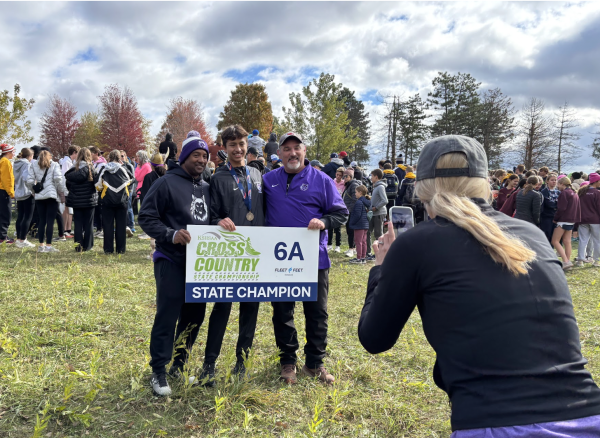 6A state champion junior Jacob D'Souza (center) at the awards ceremony with assistant coach Edward Thomas (left) and head coach Rob Marriott (right) after his race, Nov. 1.