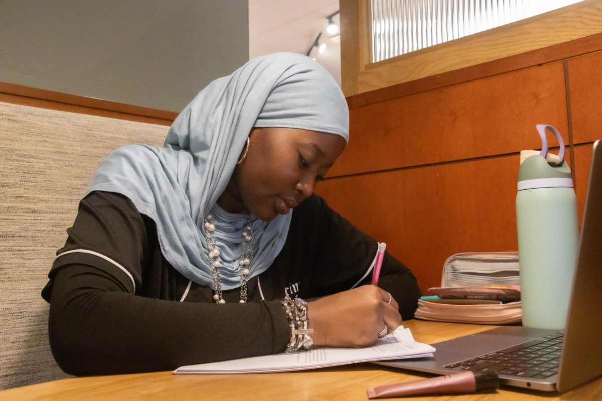 During a study session at Panera Bread, Feb. 18, senior Eman Abdalla is preparing for an upcoming test in her AP Statistics class by reviewing her homework for the current unit. “Usually when I do math homework I like to listen to music or some sort of background noise to block out my thoughts from distracting me,” Abdalla said. “Sometimes after I study I reward myself with something or just keep it in mind to boost my day and make me feel happier.”