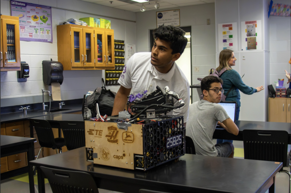Senior Srijan Singh demonstrates a robot at the Blue Valley Northwest robotics club meeting.